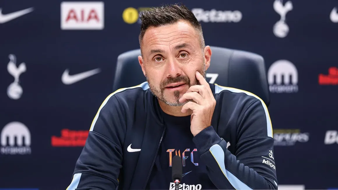The head coach speaking at a press conference